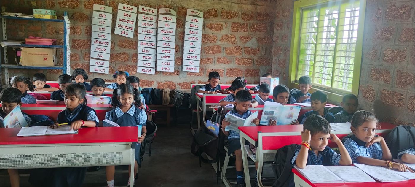 Young students reading Kannada books