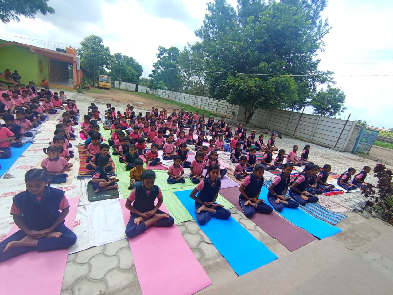 Students doing morning yoga together in the school courtyard